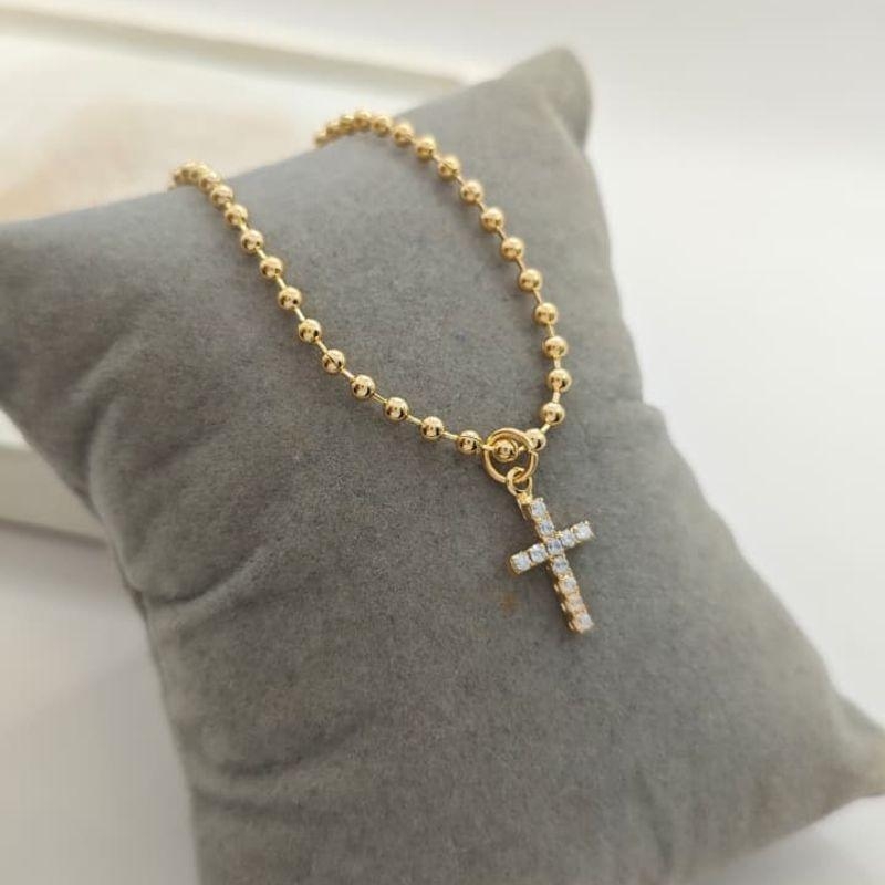 pulseira de bolinha e cruz