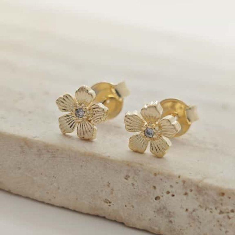 brinco flor com ponto de luz