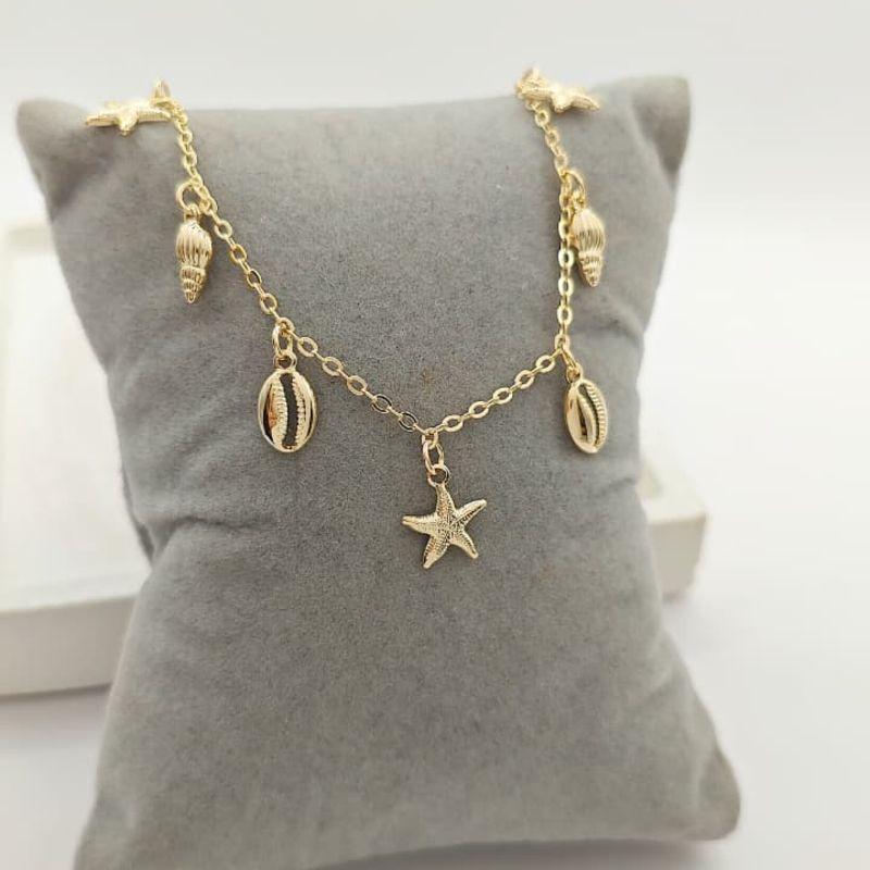 tornozeleira com búzio, estrela e concha
