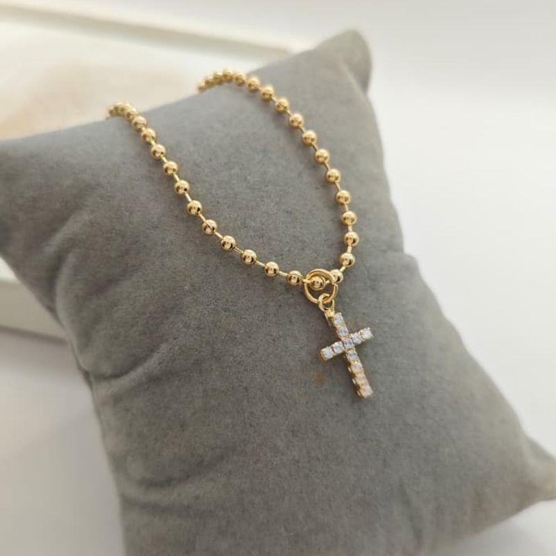 pulseira de bolinha e cruz